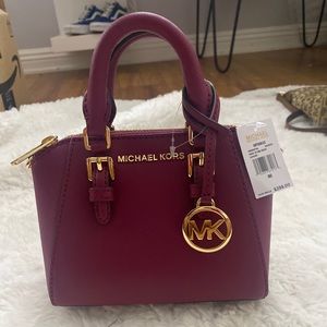 Magenta Michael Kors cross  body mini purse